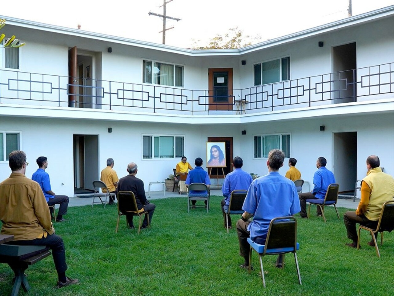 Monks meditate outside at the Mother Center